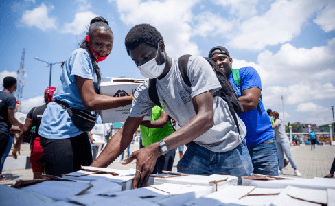 Man arranging books for poor children in a charity program